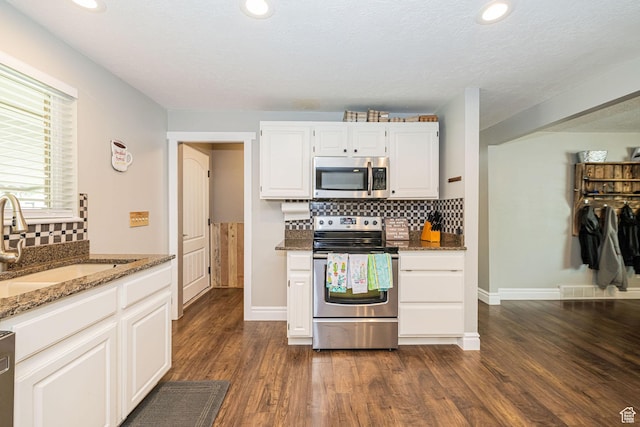 75 S 300 W, Morgan, UT 84050 - kitchen featuring stone counters, appliances with stainless steel finishes, backsplash, and dark wood finished floors