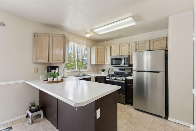 668 N 1370 W, Pleasant Grove, UT 84062 - kitchen with light brown cabinetry, appliances with stainless steel finishes, a sink, light countertops, and a peninsula