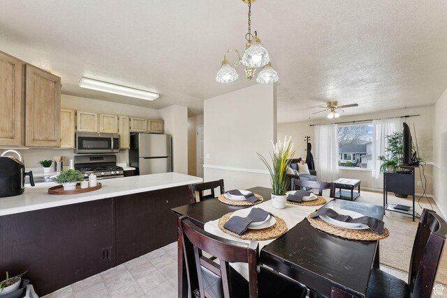 668 N 1370 W, Pleasant Grove, UT 84062 - kitchen with appliances with stainless steel finishes, light brown cabinets, light countertops, ceiling fan with notable chandelier, and a peninsula