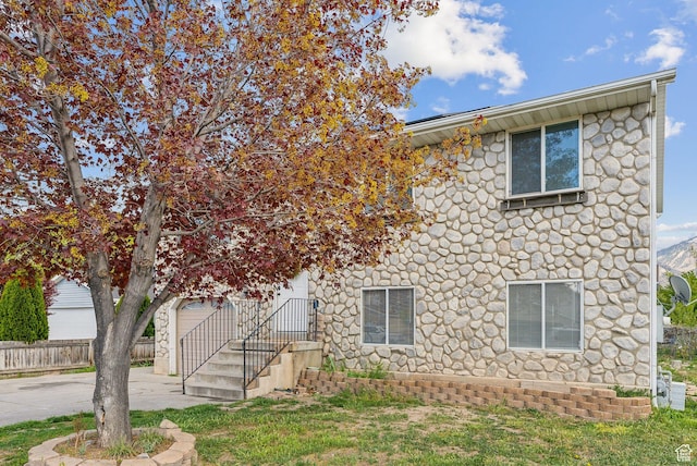 668 N 1370 W, Pleasant Grove, UT 84062 - colonial inspired home with a garage, fence, stone siding, and concrete driveway