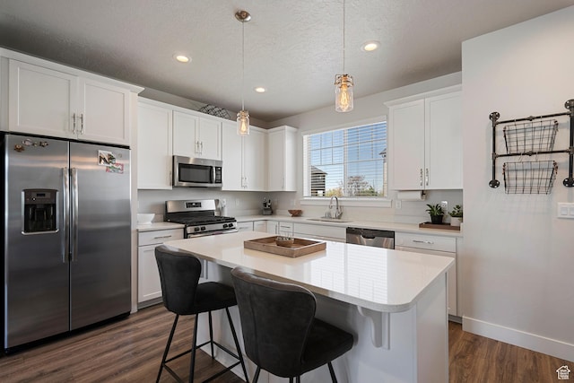 1940 S 200 W Unit 16, Bountiful, UT 84010 - kitchen featuring appliances with stainless steel finishes, a sink, light countertops, dark wood finished floors, and a center island