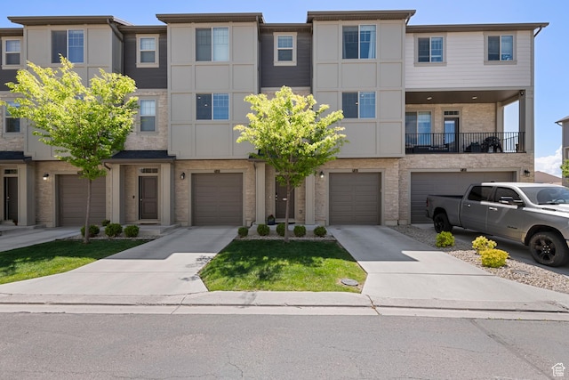 1940 S 200 W Unit 16, Bountiful, UT 84010 - view of property with an attached garage, driveway, and brick siding