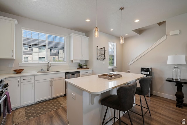 1940 S 200 W Unit 16, Bountiful, UT 84010 - kitchen with dark wood-style flooring, a breakfast bar, a center island, white cabinetry, and a sink