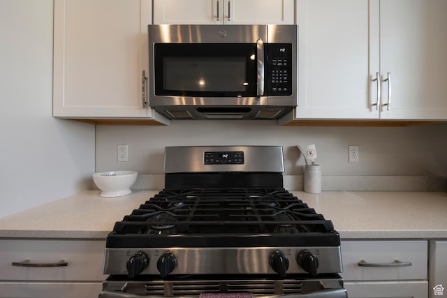 1940 S 200 W Unit 16, Bountiful, UT 84010 - kitchen with appliances with stainless steel finishes, white cabinets, and light stone counters