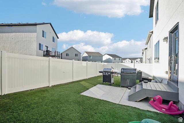 view of yard with a patio, a residential view, and a fenced backyard