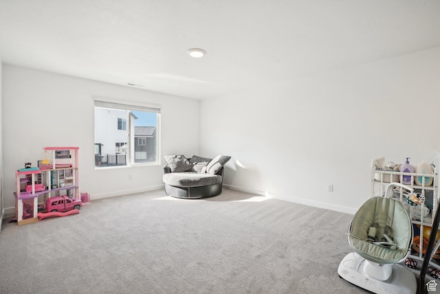 rec room with baseboards and carpet