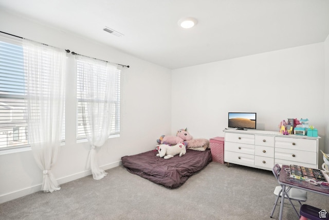 carpeted bedroom with baseboards, multiple windows, and visible vents