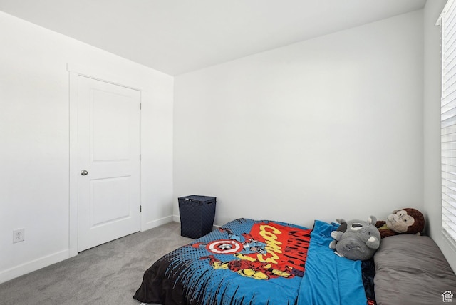 carpeted bedroom with baseboards and multiple windows
