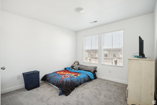 bedroom featuring baseboards, carpet flooring, and visible vents