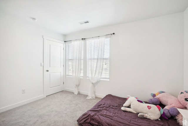 carpeted bedroom with baseboards, visible vents, and multiple windows