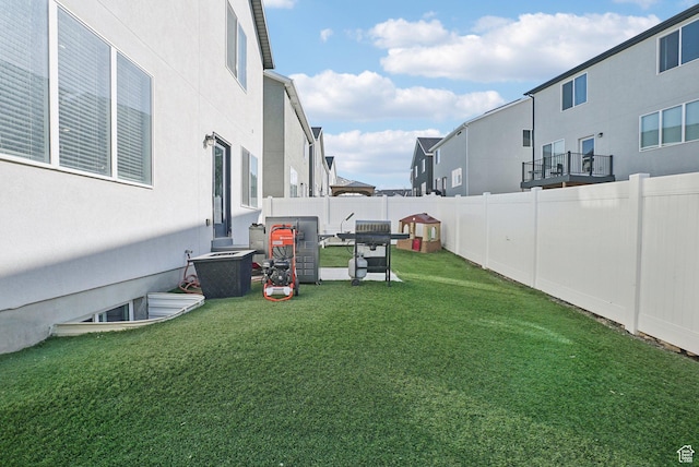 view of yard with a fenced backyard and a residential view