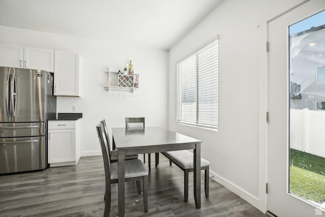 dining room with baseboards and dark wood-style flooring