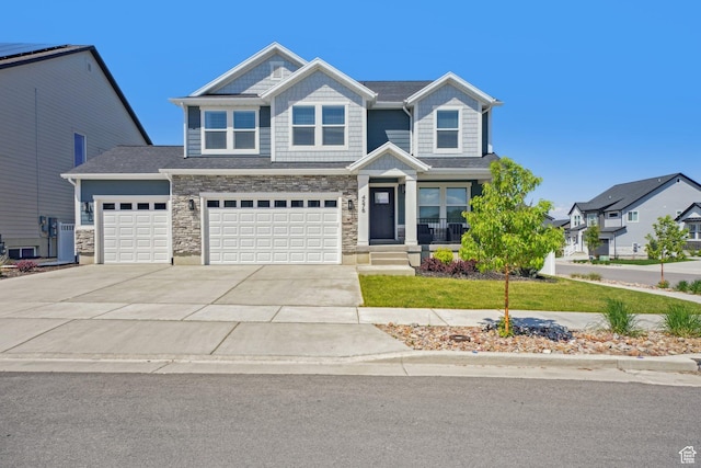 4576 W Sentry Dr, Riverton, UT 84096 - view of front of property with stone siding, concrete driveway, a porch, a garage, and a front lawn
