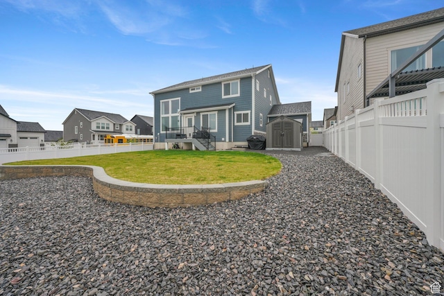 4576 W Sentry Dr, Riverton, UT 84096 - back of house featuring a storage unit, an outbuilding, and a residential view