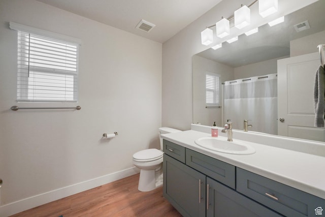 4576 W Sentry Dr, Riverton, UT 84096 - full bathroom with baseboards, wood finished floors, toilet, vanity, and a shower with curtain