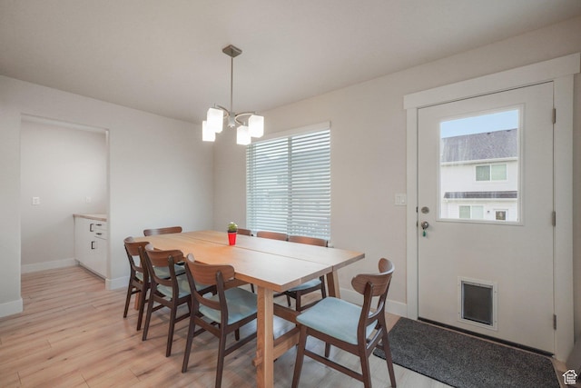 4576 W Sentry Dr, Riverton, UT 84096 - dining space with a chandelier, baseboards, and light wood-style flooring