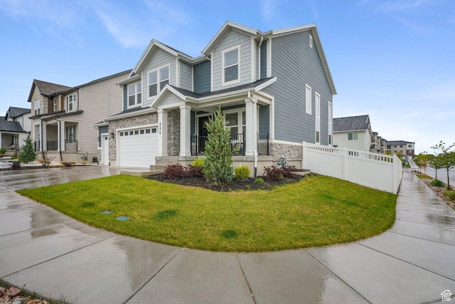 4576 W Sentry Dr, Riverton, UT 84096 - view of front of house featuring stone siding, concrete driveway, an attached garage, and a residential view