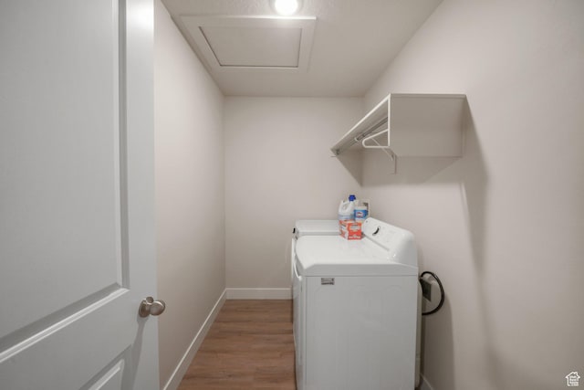 4576 W Sentry Dr, Riverton, UT 84096 - laundry area with wood finished floors, washing machine and clothes dryer, and baseboards