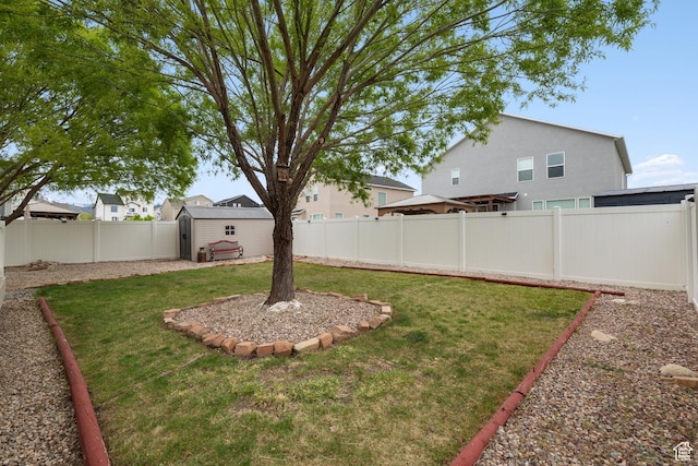 869 N Petro Dr W, Tooele, UT 84074 - view of yard featuring a fenced backyard, an outdoor structure, and a shed