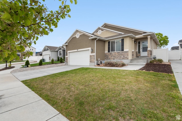 869 N Petro Dr W, Tooele, UT 84074 - craftsman-style home featuring fence, concrete driveway, an attached garage, stone siding, and stucco siding
