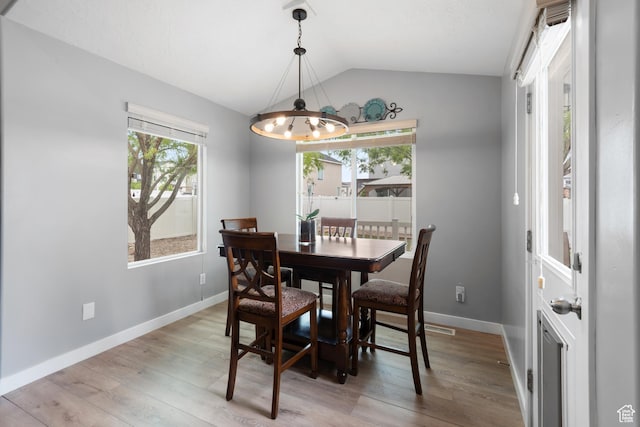869 N Petro Dr W, Tooele, UT 84074 - dining area with an inviting chandelier, baseboards, light wood-style flooring, and lofted ceiling