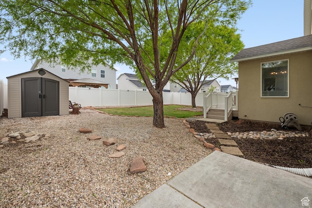 869 N Petro Dr W, Tooele, UT 84074 - view of yard with an outbuilding, a fenced backyard, a patio area, and a storage unit