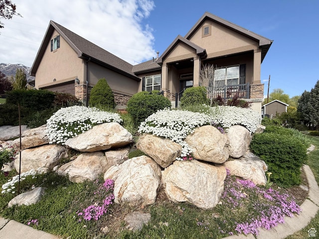 4116 N 800 W, Pleasant View, UT 84414 - view of front facade featuring an attached garage, stone siding, and stucco siding