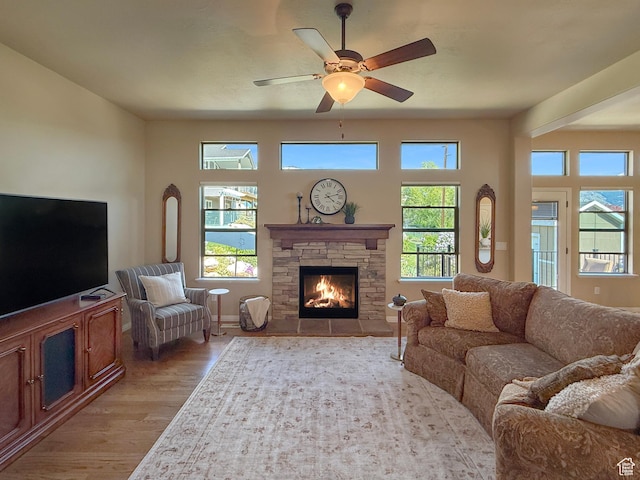 4116 N 800 W, Pleasant View, UT 84414 - living area featuring ceiling fan, a fireplace, light wood finished floors, and a wealth of natural light