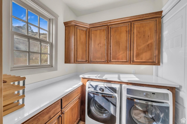 laundry area with washer and dryer and cabinet space