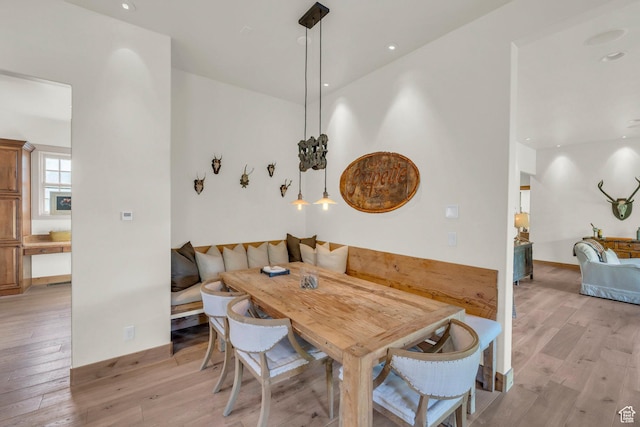 dining space featuring light wood-style floors, baseboards, recessed lighting, and breakfast area
