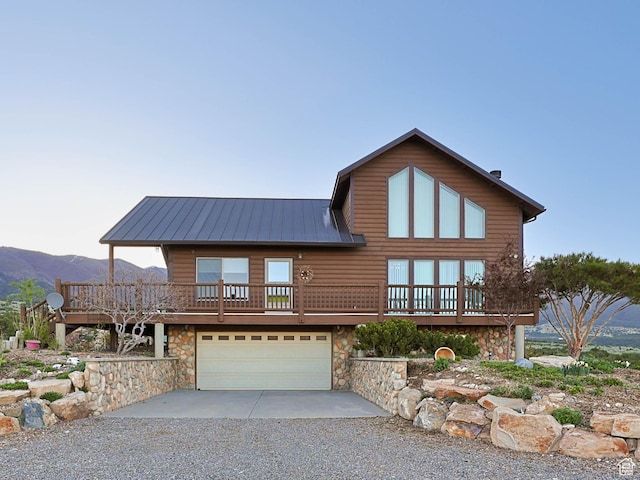 609 E 900 S, Stockton, UT 84071 - view of front of home featuring an attached garage, driveway, stone siding, and metal roof
