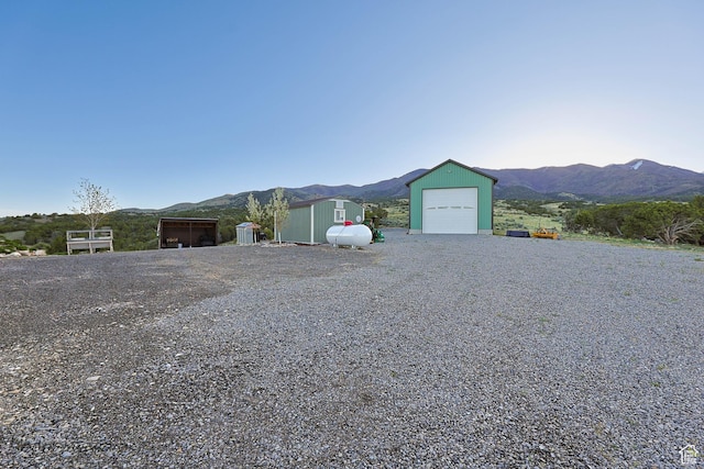 609 E 900 S, Stockton, UT 84071 - ranch-style house with a mountain view, an outdoor structure, and a garage