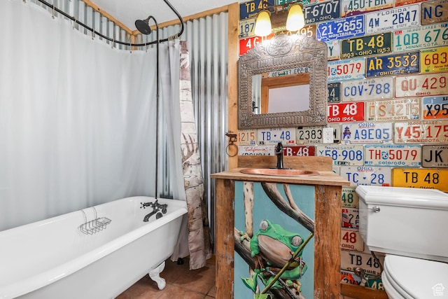 609 E 900 S, Stockton, UT 84071 - bathroom featuring a sink, tile patterned flooring, toilet, a shower with curtain, and a soaking tub