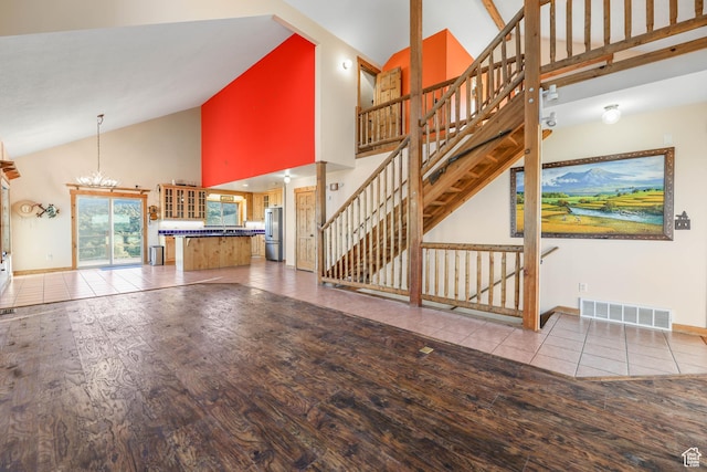 609 E 900 S, Stockton, UT 84071 - unfurnished living room featuring visible vents, wood finished floors, stairway, high vaulted ceiling, and baseboards