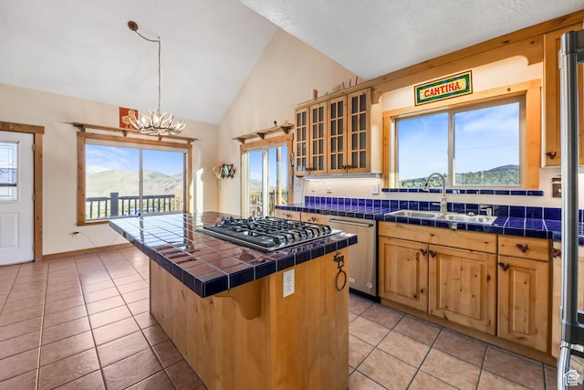 609 E 900 S, Stockton, UT 84071 - kitchen featuring a sink, tile counters, stainless steel appliances, light tile patterned floors, and a wealth of natural light