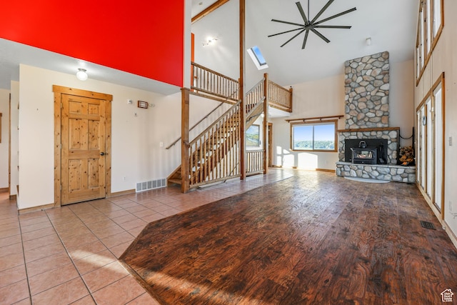 609 E 900 S, Stockton, UT 84071 - unfurnished living room with visible vents, stairs, a stone fireplace, and high vaulted ceiling