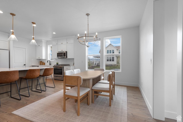 11254 S Bingham Rim Rd W, South Jordan, UT 84009 - dining area with light wood-style flooring, a chandelier, recessed lighting, and baseboards