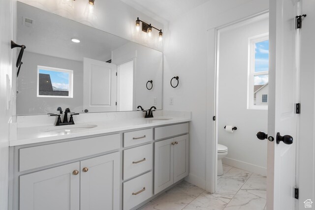 11254 S Bingham Rim Rd W, South Jordan, UT 84009 - bathroom with marble look tiles, toilet, healthy amount of natural light, and double vanity