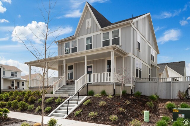 11254 S Bingham Rim Rd W, South Jordan, UT 84009 - view of front of home with board and batten siding, covered porch, and stairway