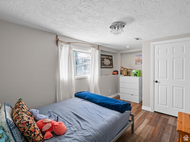 3855 W Elwood Way S, West Jordan, UT 84088 - bedroom with wood-type flooring, a textured ceiling, baseboards, and visible vents