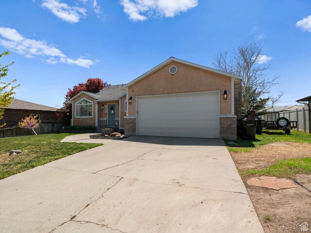 3855 W Elwood Way S, West Jordan, UT 84088 - ranch-style house with driveway, fence, a front lawn, an attached garage, and stucco siding