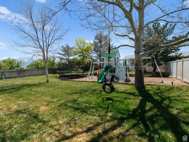 3855 W Elwood Way S, West Jordan, UT 84088 - view of yard featuring a playground, a trampoline, and a fenced backyard