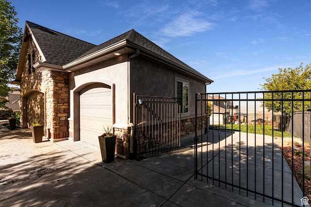 398 S Lofty Ln E, North Salt Lake, UT 84054 - view of home's exterior with a garage, roof with shingles, fence, and stone siding