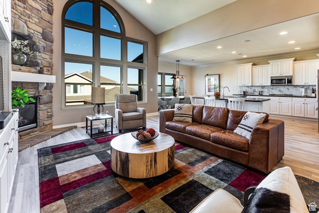 398 S Lofty Ln E, North Salt Lake, UT 84054 - living area featuring crown molding, light wood finished floors, a fireplace, recessed lighting, and lofted ceiling