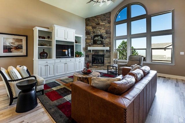 398 S Lofty Ln E, North Salt Lake, UT 84054 - living room with baseboards, light wood-style flooring, high vaulted ceiling, and a fireplace