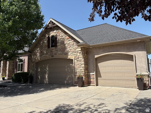 398 S Lofty Ln E, North Salt Lake, UT 84054 - french country home featuring stone siding, roof with shingles, concrete driveway, an attached garage, and stucco siding