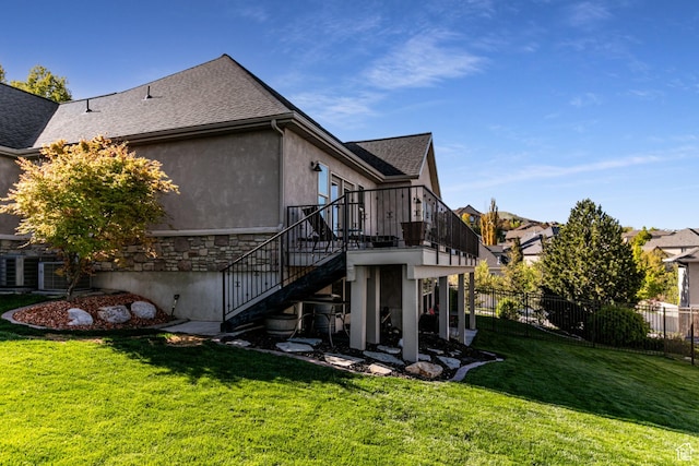 398 S Lofty Ln E, North Salt Lake, UT 84054 - rear view of property featuring fence, a shingled roof, stucco siding, stairway, and a lawn