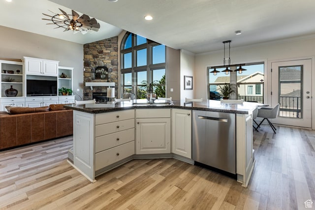 398 S Lofty Ln E, North Salt Lake, UT 84054 - kitchen with stainless steel dishwasher, a stone fireplace, open floor plan, a sink, and light wood finished floors