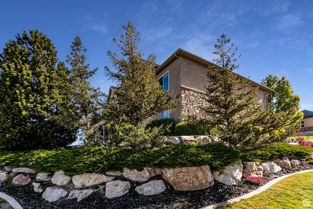 398 S Lofty Ln E, North Salt Lake, UT 84054 - view of side of home featuring stucco siding and stone siding