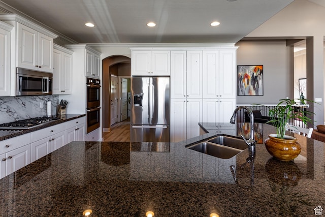 398 S Lofty Ln E, North Salt Lake, UT 84054 - kitchen featuring a sink, white cabinetry, appliances with stainless steel finishes, and arched walkways